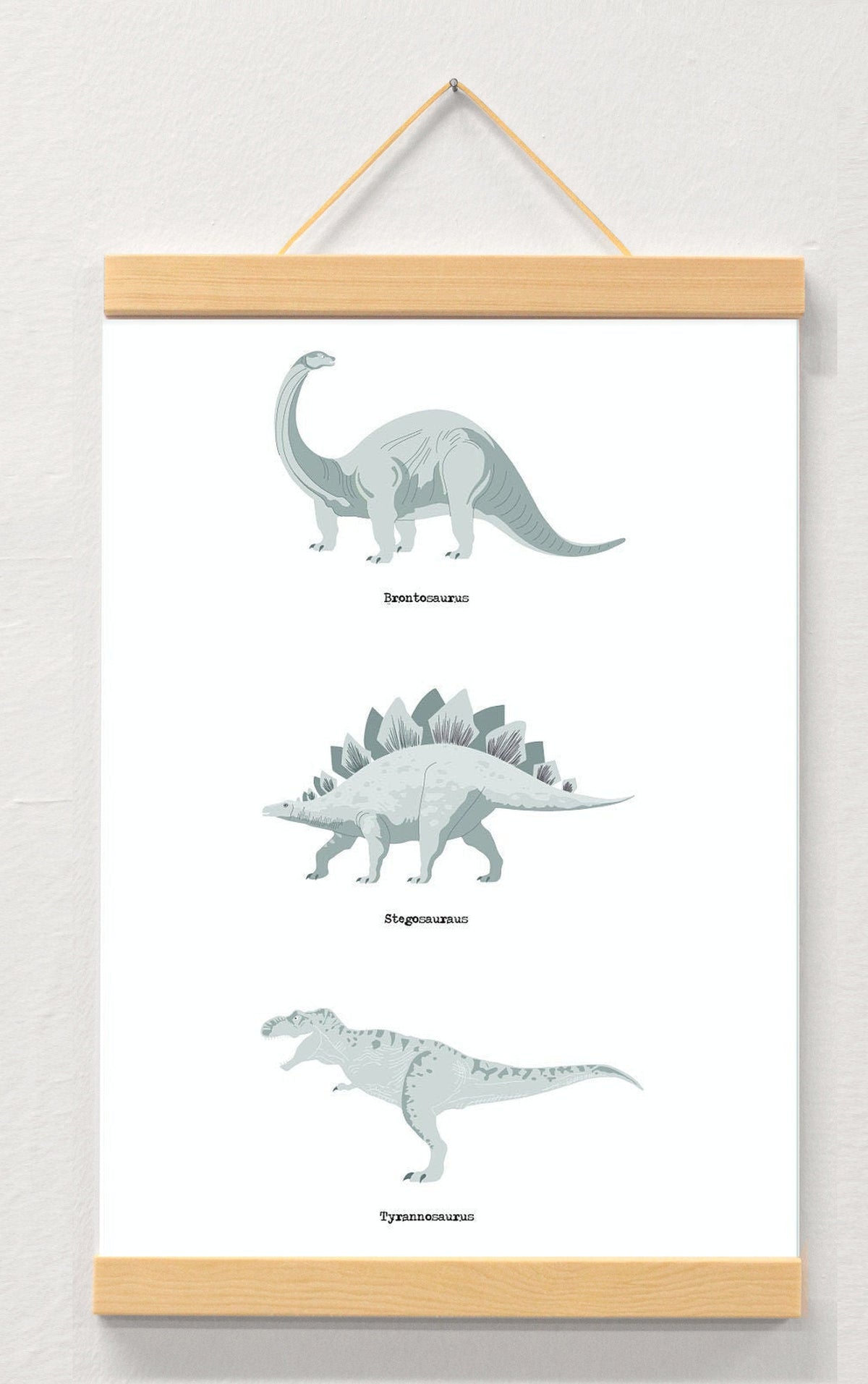 Dinosaur nursery print displayed in a wooden magnetic hanger