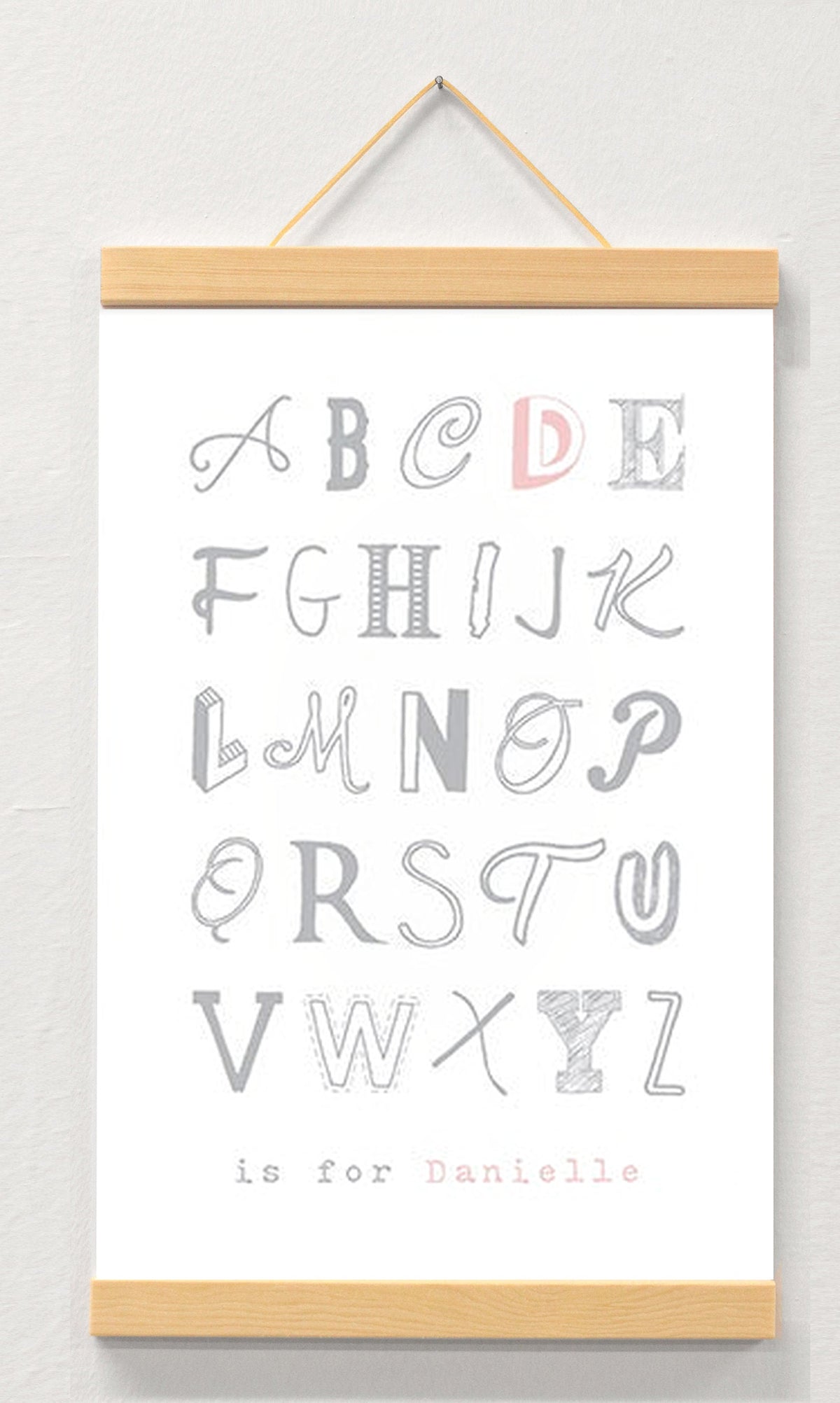 Alphabet print - girl's name displayed in a wooden magnetic hanger
