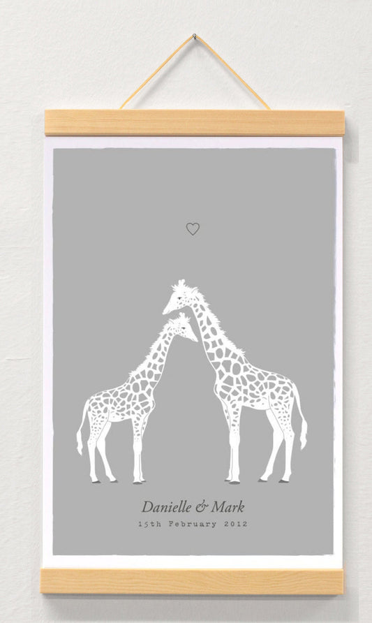 Personalised giraffe couple print displayed in a wooden magnetic hanger