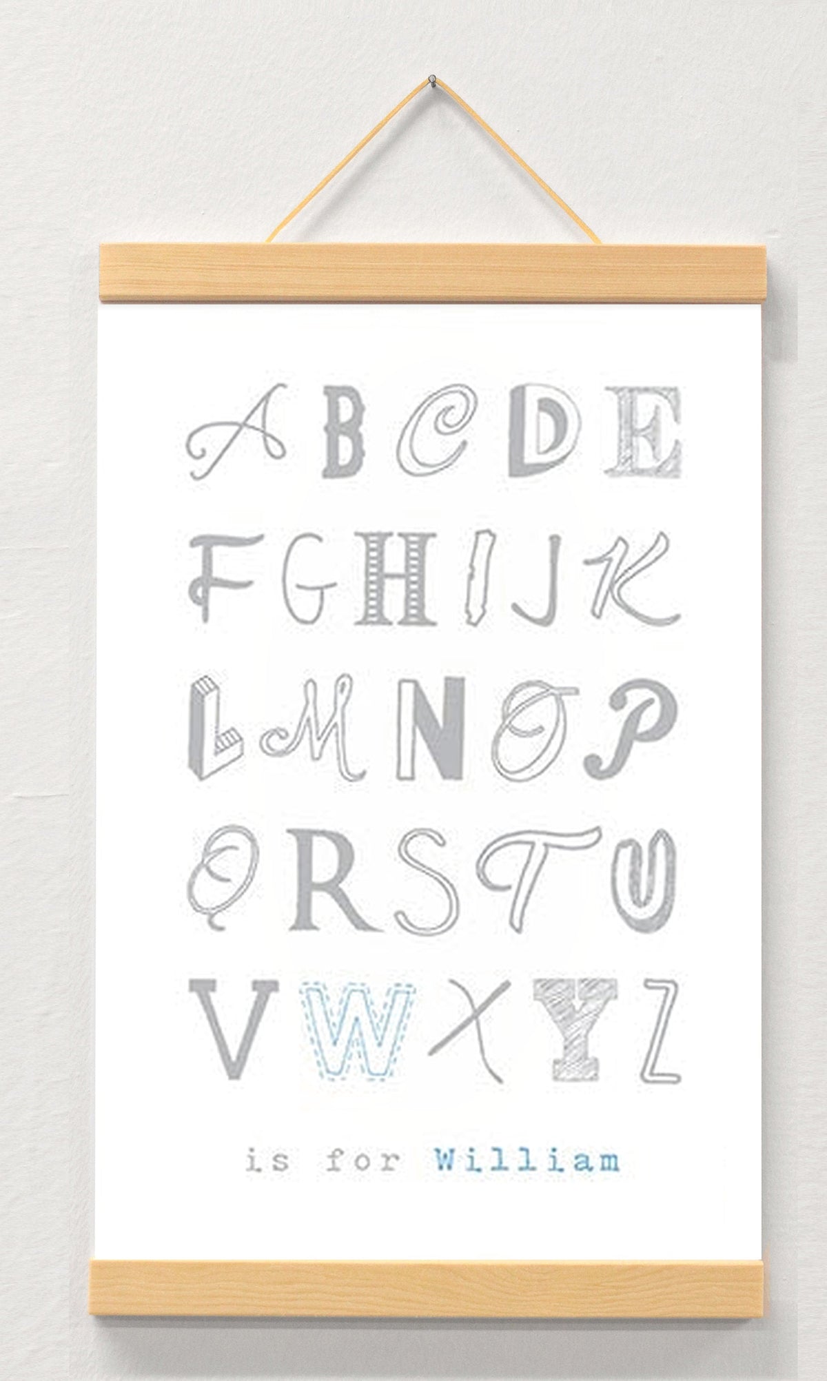 Boy name nursery art displayed in a wooden magnetic hanger